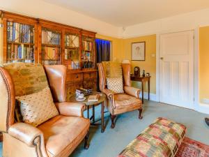 a living room with a couch and two chairs at Brandon in Sutton on Sea