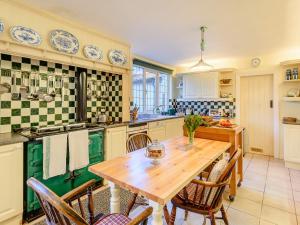 a kitchen with a wooden table and chairs at Brandon in Sutton on Sea