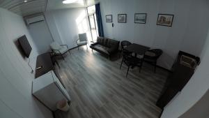 an overhead view of a living room with a couch and chairs at Hotel Laimoa in Apia