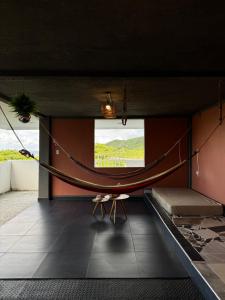 a room with a hammock in the middle of a room at Posada ontimeview in Providencia