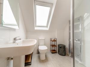 a bathroom with a sink and a toilet and a window at Springbank in Brodick