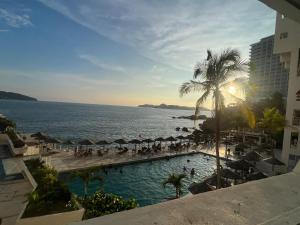a view of a swimming pool next to the ocean at Suite con acceso a playa y vista espectacular in Acapulco
