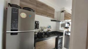 a kitchen with a stainless steel refrigerator at Apartamento 2 quartos para a cop 30 in Ananindeua