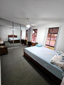 a large bedroom with a large bed and a desk at Campbelltown Family Retreat 3-Bedroom Home in Campbelltown