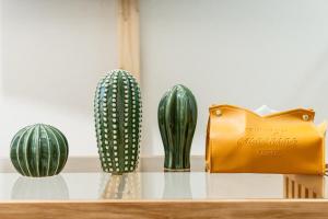 a shelf with three cactuses and a yellow purse at リトリートコートキャナルシティ in Fukuoka
