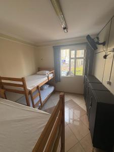 a bedroom with two bunk beds and a window at AS Pousada Alojamento in Sao Jose do Rio Preto +6 photos