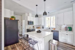 a kitchen with white cabinets and a black refrigerator at Stay Portland - Brand New Luxury Mt Hood Cabin in Rhododendron