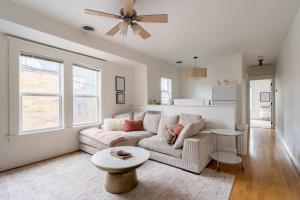 a living room with a couch and a ceiling fan at The Bohemian Spirit - Live Music, Eateries & Bars in Portland