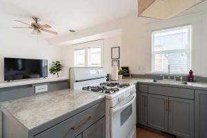a kitchen with a stove and a sink at The Bohemian Spirit - Live Music, Eateries & Bars in Portland