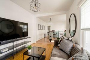 a living room with a couch and a tv at Hipster Vibe Apartment - Food Carts & Live Music in Portland