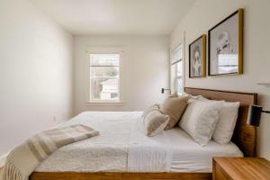 a white bedroom with a bed with white sheets and pillows at Hipster Vibe Apartment - Food Carts & Live Music in Portland +29 photos