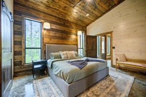 a bedroom with a bed in a room with wooden walls at Nectars Ridge - Heated Pool, Hot Tub, Ping Pong, Arcade in Broken Bow +53 photos
