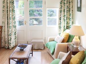a living room with a couch and a table at The Wee House in Muthill