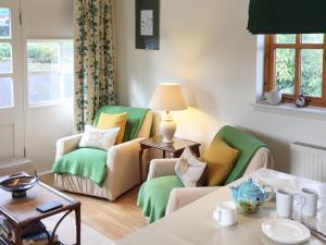 a living room with two chairs and a table at The Wee House in Muthill