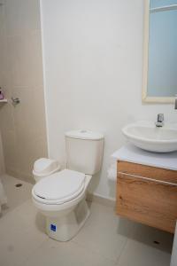 a bathroom with a toilet and a sink at La Puerta del Ángel LOW COST in Ricaurte +75 photos