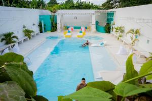 a pool at a hotel with two people in the water at La Puerta del Ángel LOW COST in Ricaurte