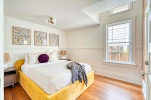 a white bedroom with a bed and a window at Overlook Gem - Steps from Mississippi in Portland