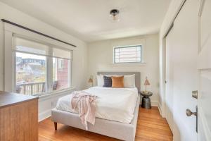 a bedroom with a bed and a window at Overlook Gem - Steps from Mississippi in Portland