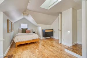 a bedroom with a bed and a television in it at Overlook Gem - Steps from Mississippi in Portland +54 photos