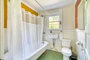 a bathroom with a tub and a toilet and a sink at Spacious 4BR - Walkable - Funky PDX Vibes in Portland