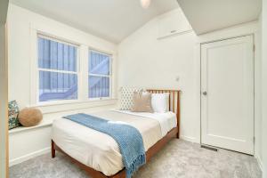 a bedroom with a bed and two windows at Spacious 4BR - Walkable - Funky PDX Vibes in Portland