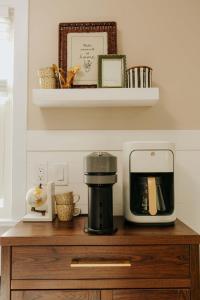 a microwave sitting on top of a wooden table at The Atlas - Family-Focused Stay for Every Journey in Fargo