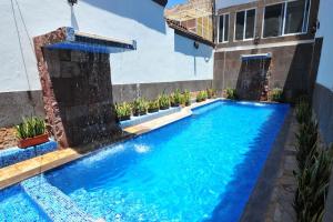 Una piscina en un patio con un edificio. en Hotel Rincon Real Suites, en Durango