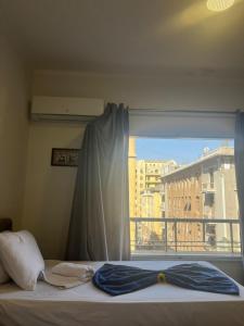 a bed with a window with a view of a city at Downtown Cairo Park Plaza Hotel in Cairo