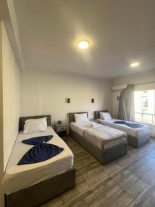 a bedroom with two beds and a window at Downtown Cairo Park Plaza Hotel in Cairo