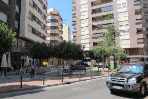 a car parked on the side of a city street at Apartament con Encanto in Castellón de la Plana
