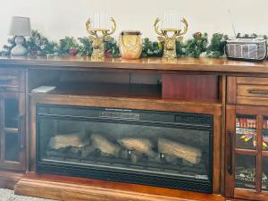 a fireplace in a living room with christmas decorations at Sea View Penthouse - Regency Mansion in Redcar