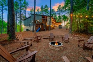 a fire pit in a park with benches and a playground at Nectars Ridge - Heated Pool, Hot Tub, Ping Pong, Arcade in Broken Bow