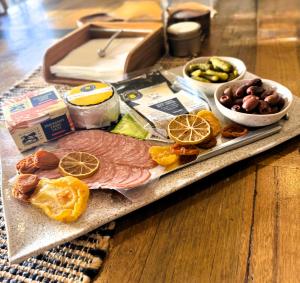 a tray of food with meat and oranges and other foods at Barossa Bed & Breakfast in Tanunda