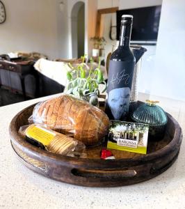 a tray with a loaf of bread and a bottle of wine at Barossa Bed & Breakfast in Tanunda
