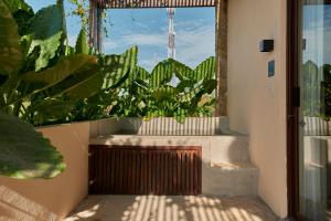a balcony with a large window with plants at ZunZún in Puerto Escondido +118 photos