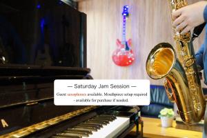 a person playing a saxophone next to a piano at Feel Osaka Yu in Osaka