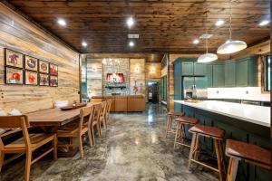 a dining room with wooden walls and a table and chairs at Nectars Ridge - Heated Pool, Hot Tub, Ping Pong, Arcade in Broken Bow