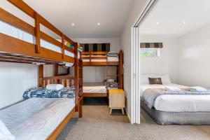 a bedroom with two bunk beds and a hallway at Kinloch Lookout in Kinloch