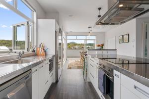 a kitchen with white cabinets and a large window at Kinloch Lookout in Kinloch