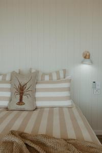 a bedroom with a bed with a spider pillow at Stones Throw - Brand New Beach House in Stokes Bay