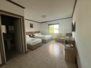 ein kleines Zimmer mit zwei Betten und einer Couch in der Unterkunft Csm Clark Hotel in Pampang