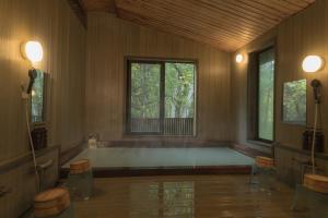 a large room with a large window and a tub at Komakusa Hotel in Matsumoto +37 photos