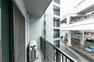 an apartment balcony with a view of a street at Gamadas BLD in Tokyo