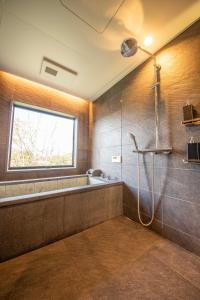 a bathroom with a shower and a sink at Doggo伊豆　愛犬と過ごす最高の時間の為に造られた貸切宿。温泉、プライベートドッグランで最高の一時を。 in Ito +43 photos