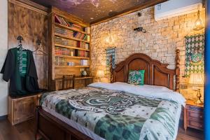 a bedroom with a bed and a brick wall at Beijing Magic Villa in Tuqiao