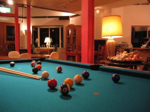 a pool table with balls on it in a room at Ernest House in Shimoda