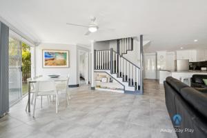a kitchen and dining room with a table and chairs at Park Beach Surfside Escape in Coffs Harbour +29 photos