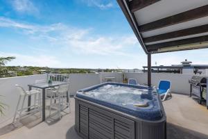 a hot tub on the roof of a house at Ocean Vista Retreat - Walk to Mooloolaba & Alex in Mooloolaba