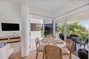 a living room with a table and chairs at Ocean Vista Retreat - Walk to Mooloolaba & Alex in Mooloolaba