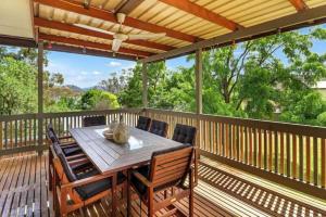 a wooden deck with a table and chairs on it at Lakeview Retreat Bonnie Doon - Sleeps 12 in Bonnie Doon
